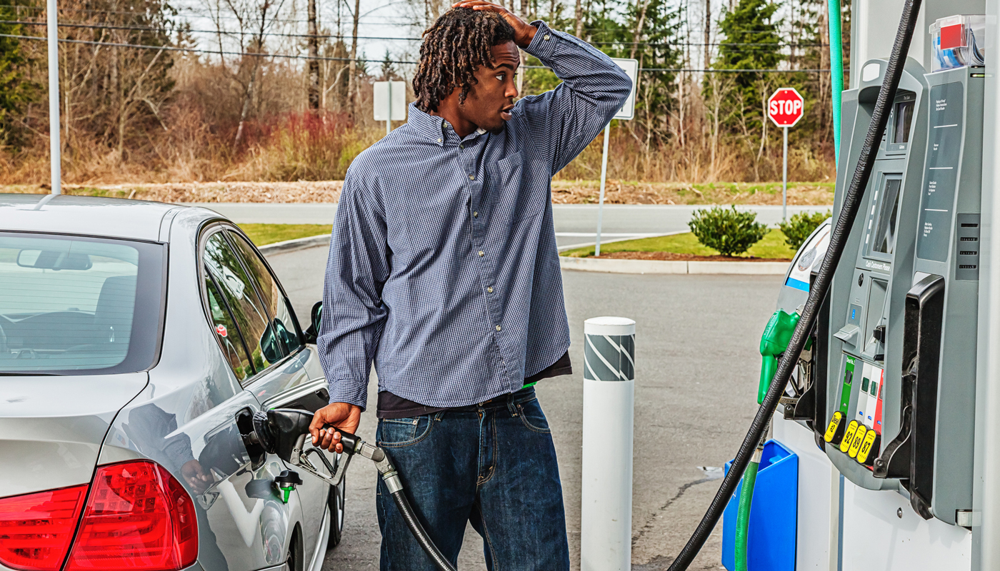 Man at the gas pump shocked at the prices