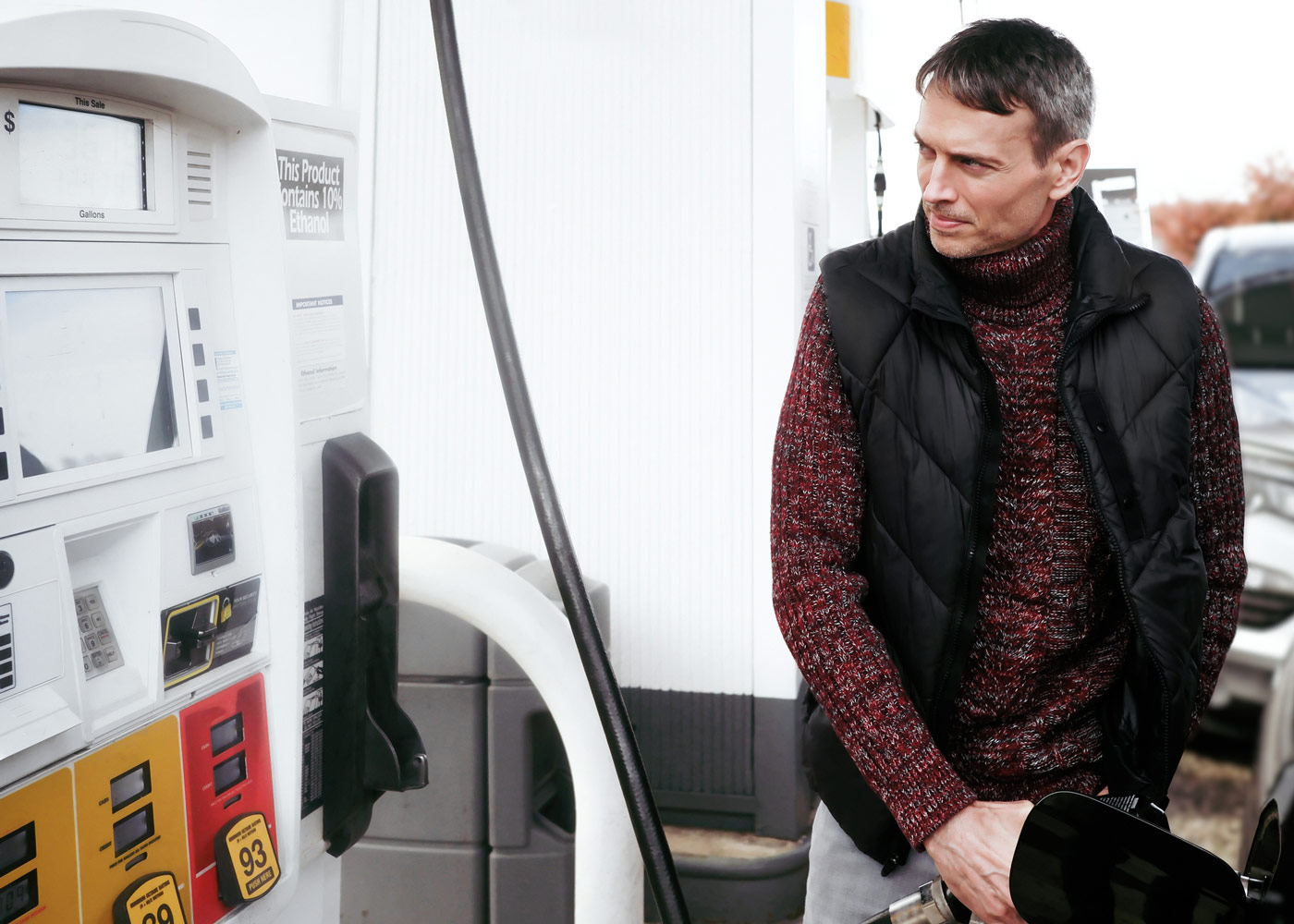 man pumping gas at a gas station