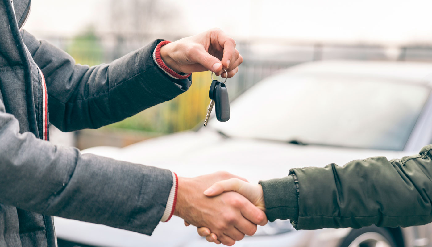 handshake over keys to a car