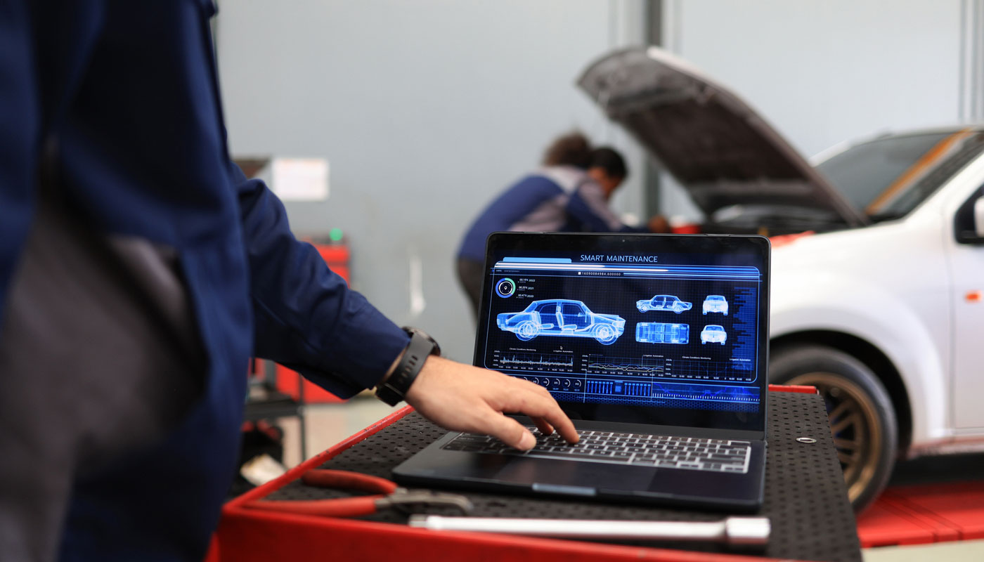 Laptop showing diagnostics for a car in shop