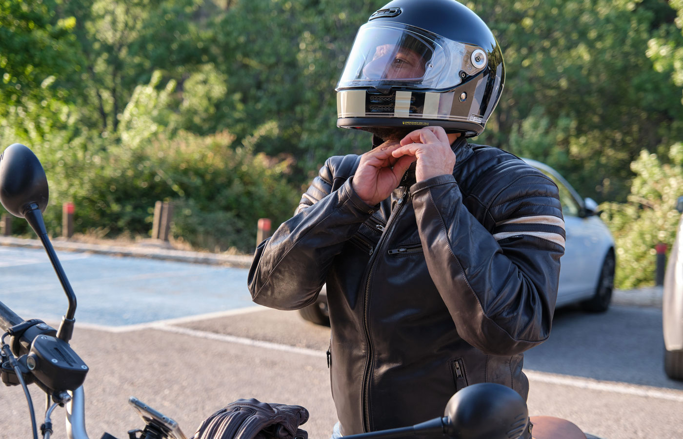 Man putting on motorcycle helmet