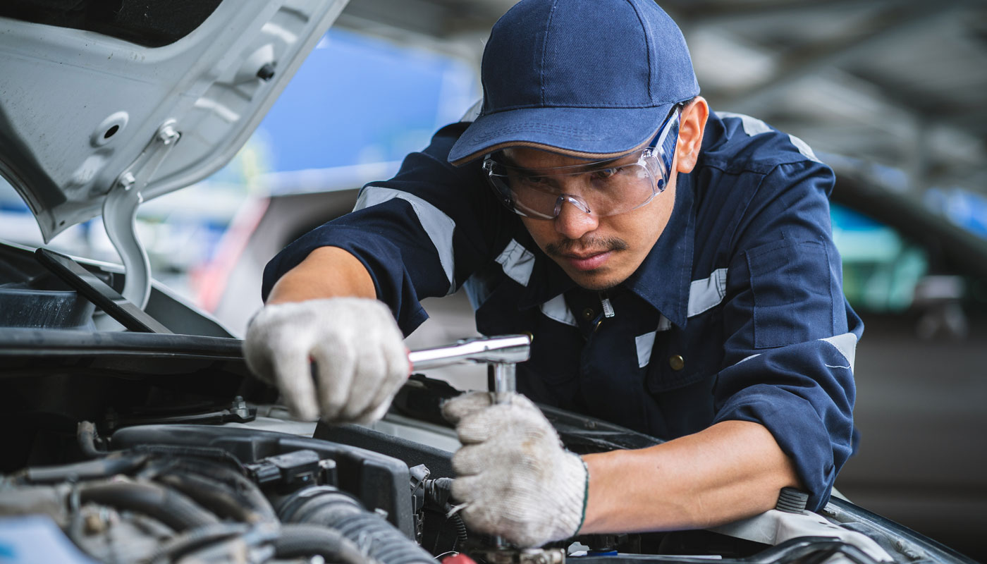 Mechanic checking the safety of a car. Maintenance of damaged parts in the garage. Maintenance repairs