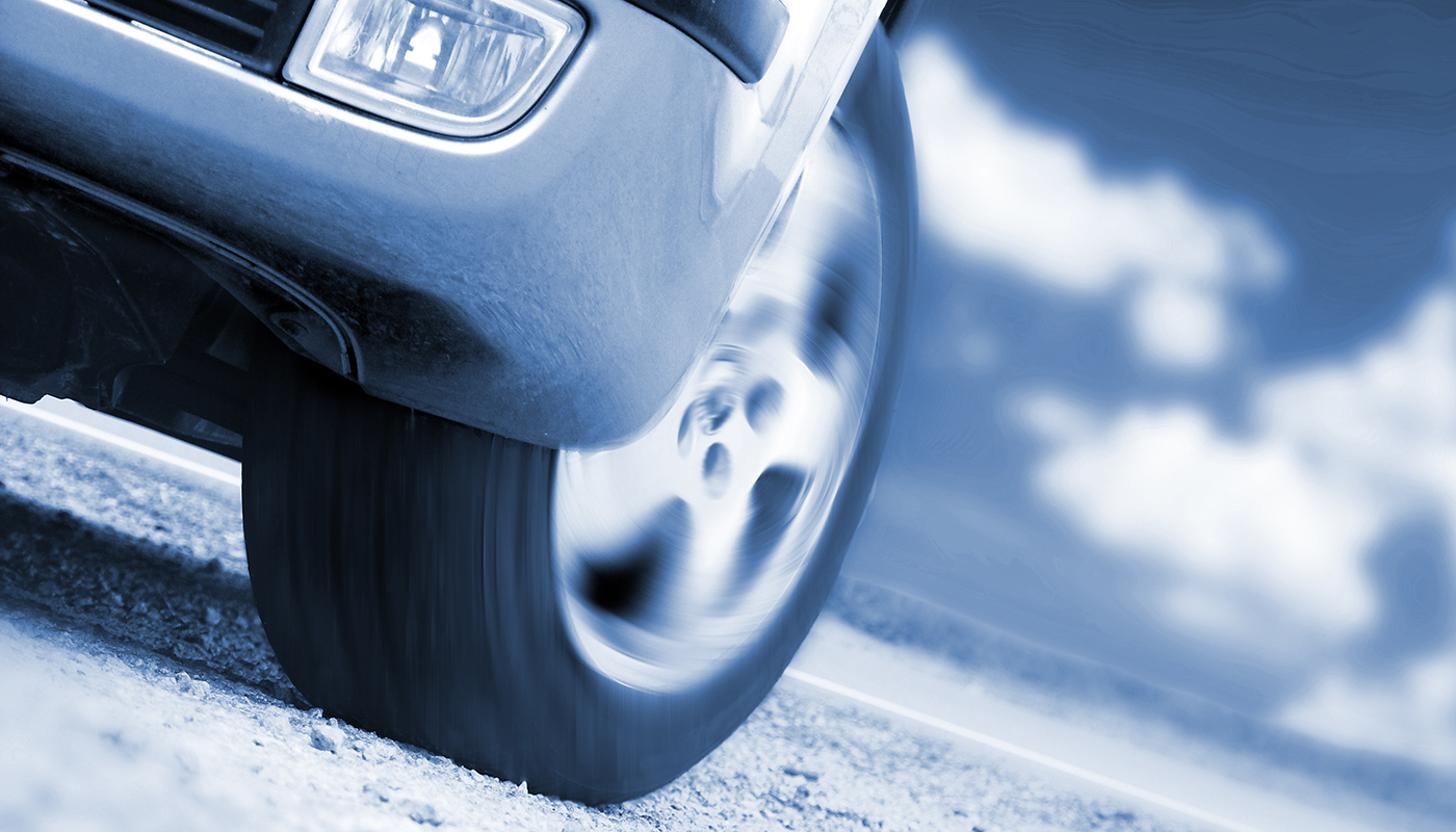 wheels of a car turning on gravel