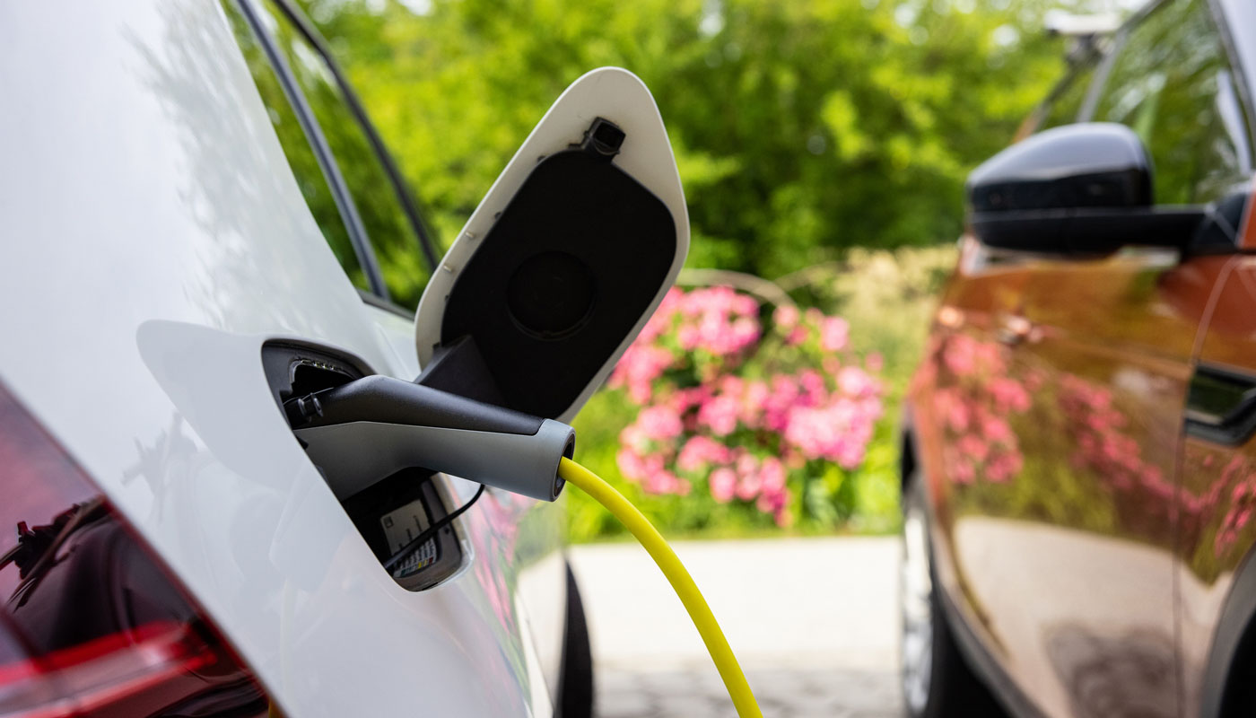 White EV car being charged at home