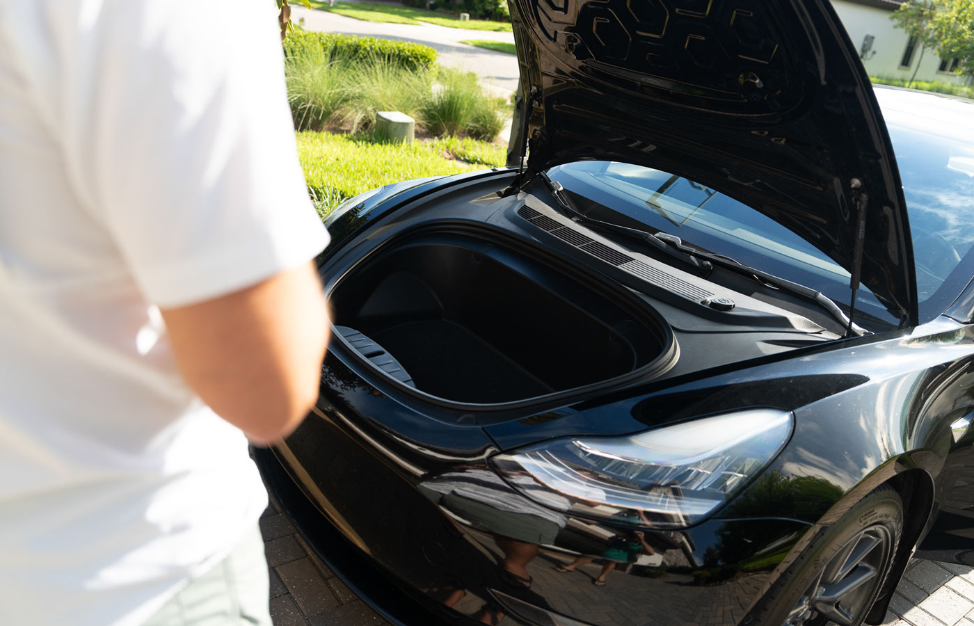 Black electric vehicle in driveway showing the Frunk