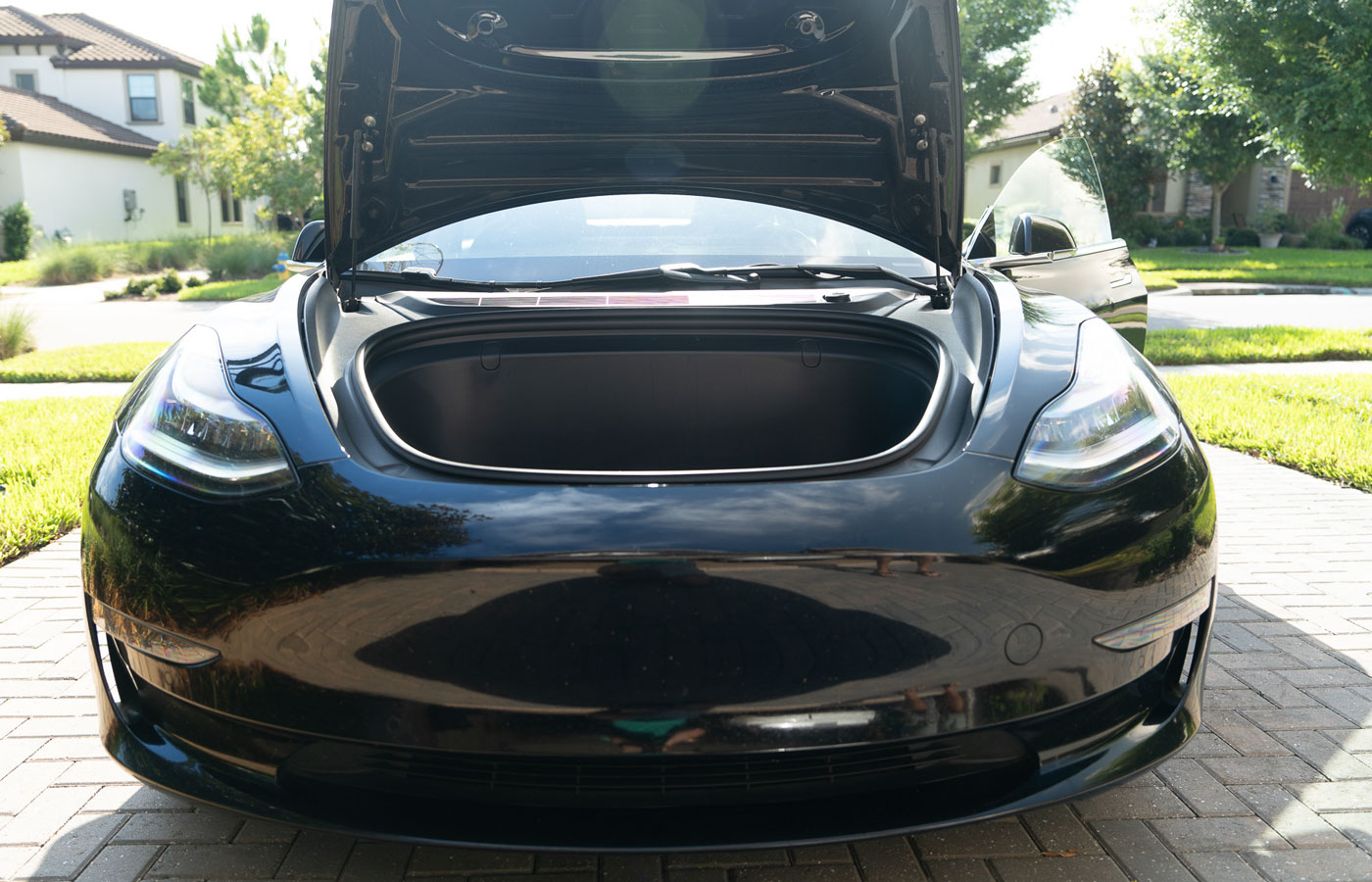 Black electric vehicle in driveway showing Frunk