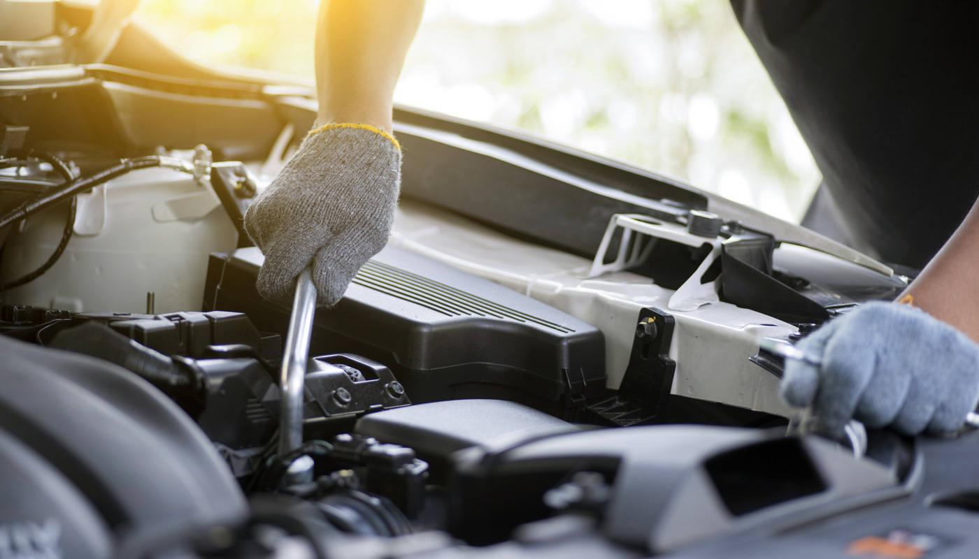 Mechanic checking car engine