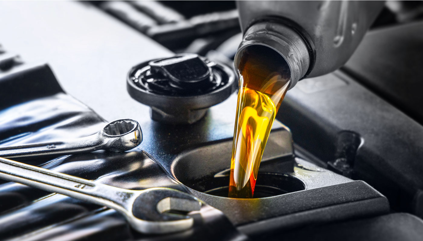 Engine oil being poured into the engine of a car