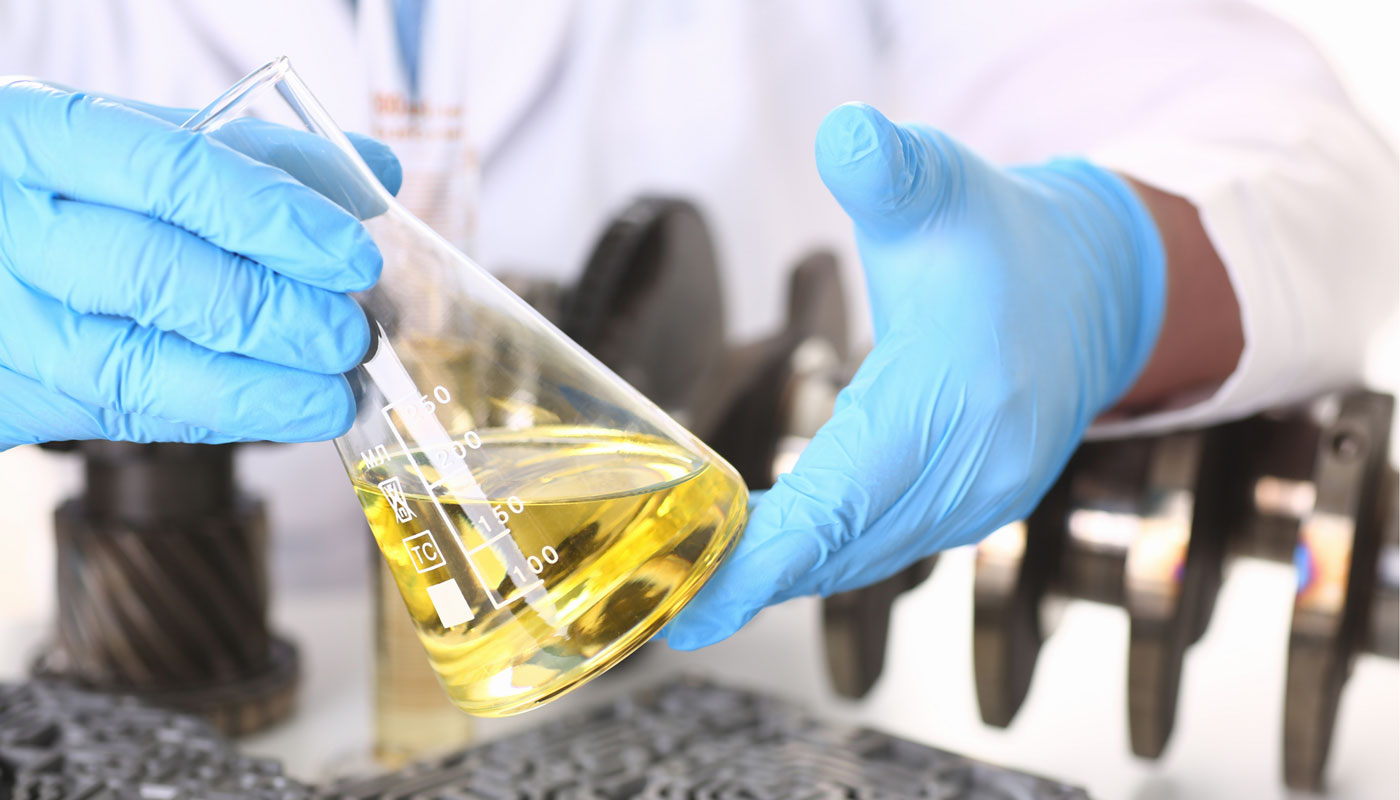 scientist working with engine oil in a lab