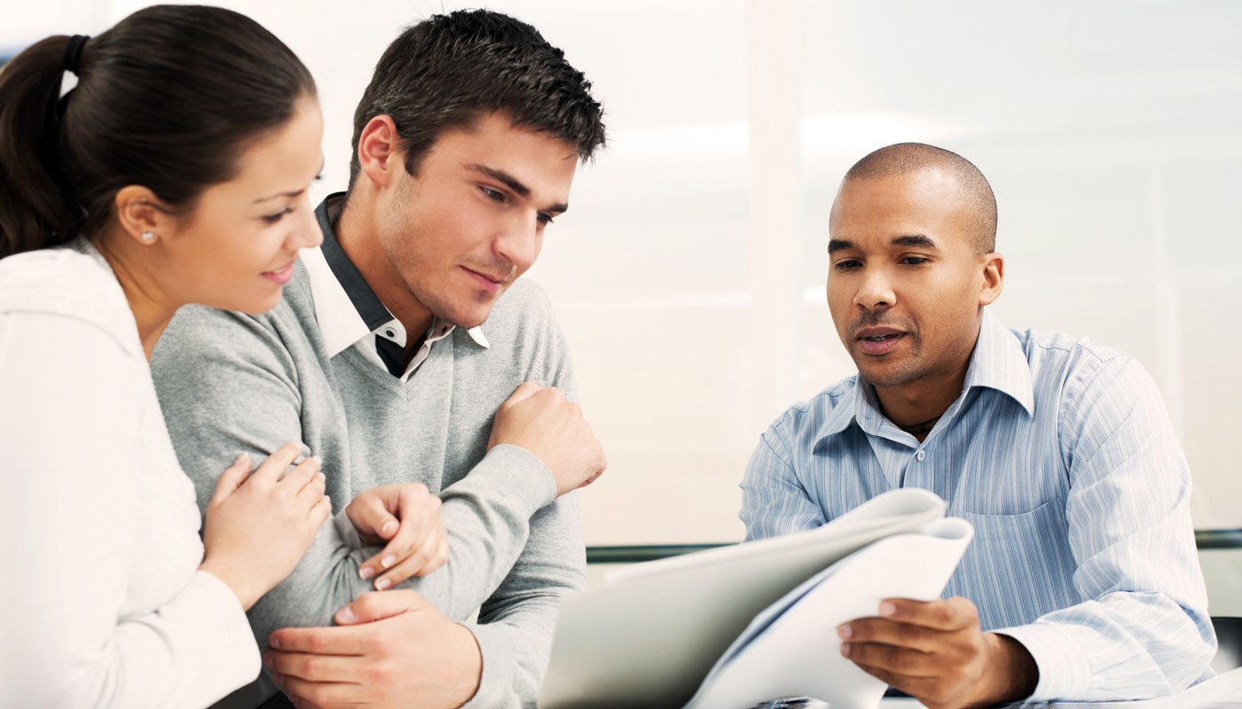 Financial planner going over documents with a couple