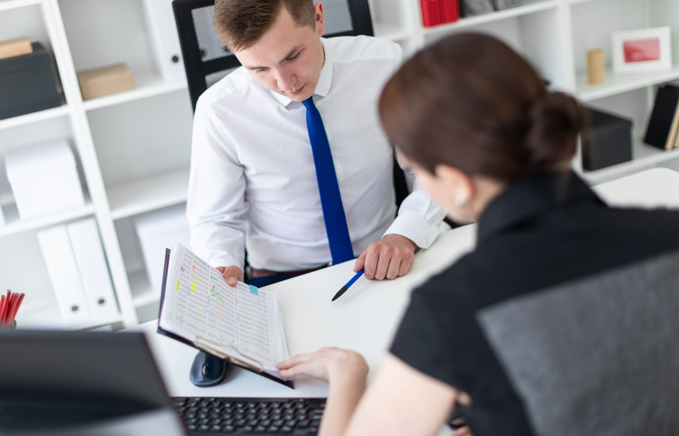 Two people looking at financial records together