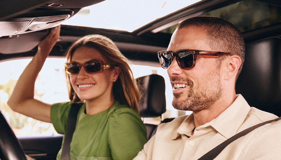 Couple riding in car with sunglasses