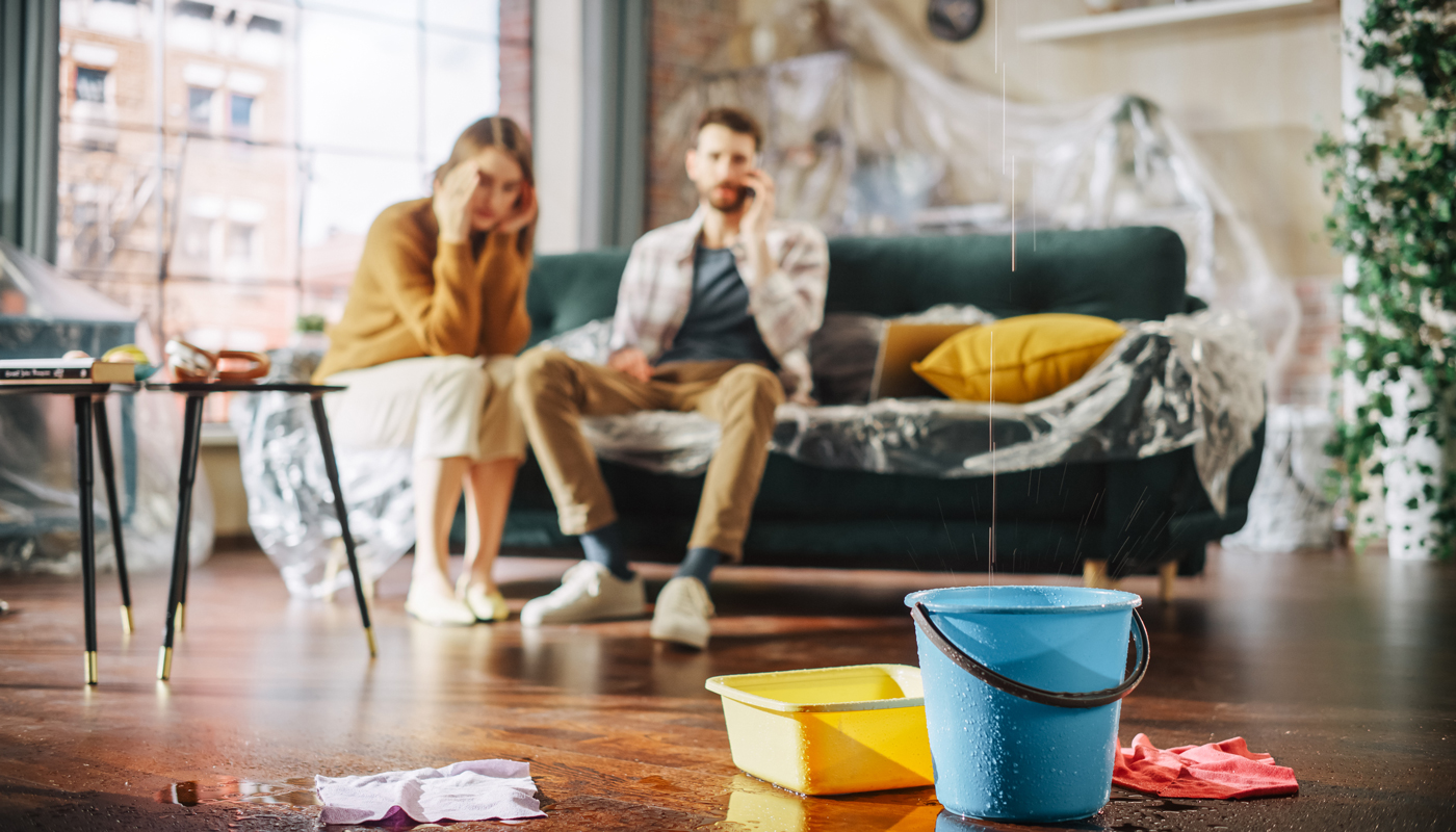 couple sitting on couch  in flooding living room