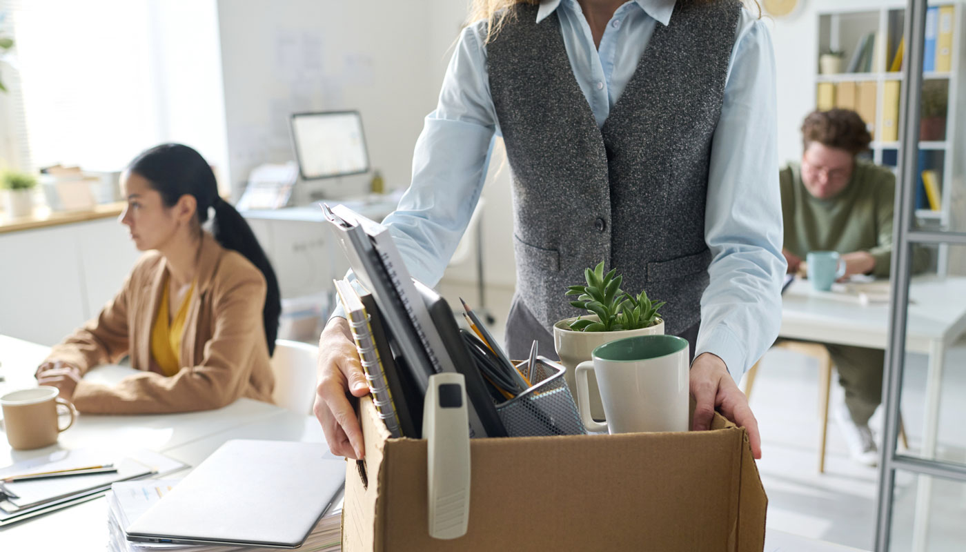 woman with packed box in office setting