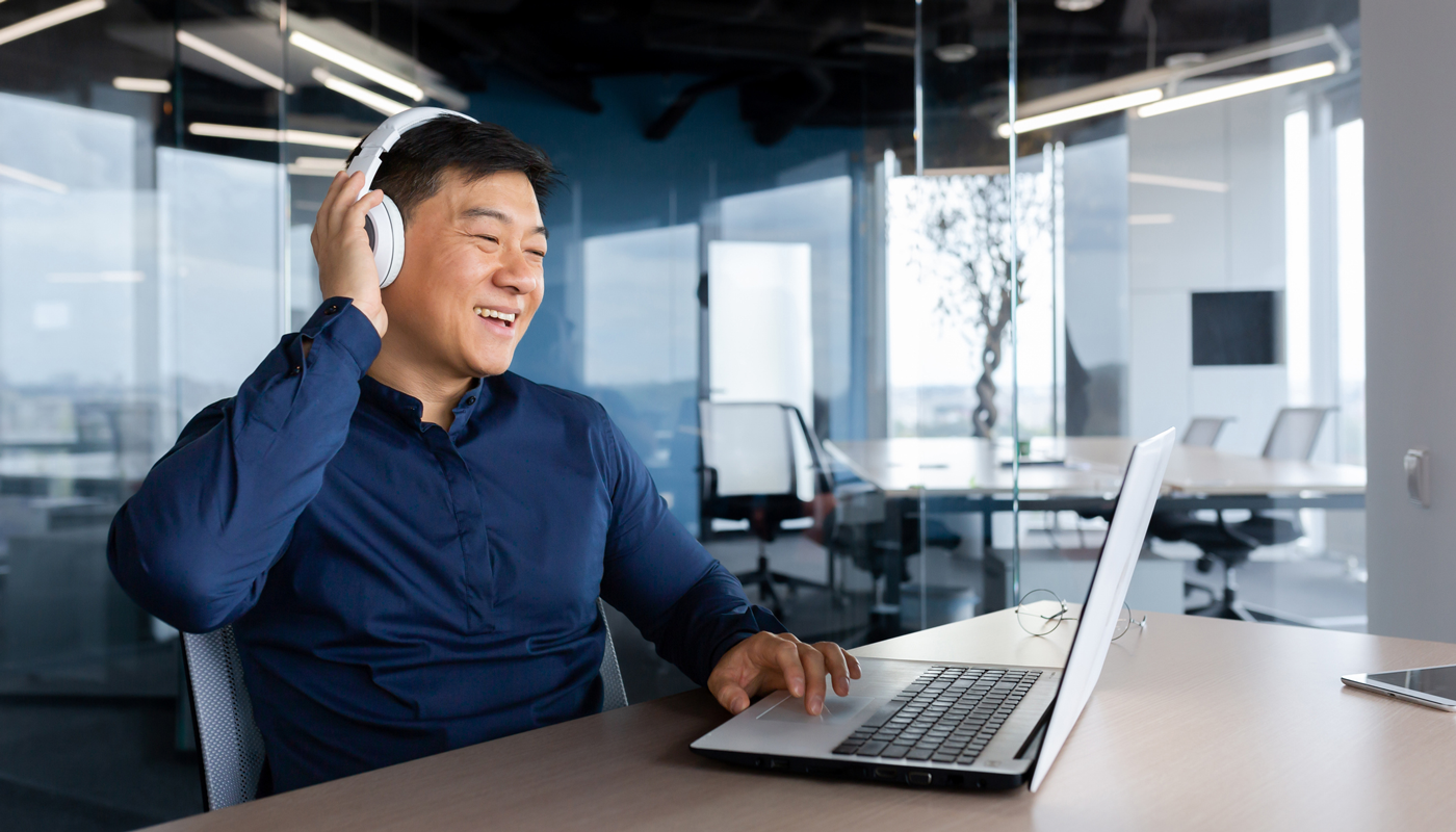 Man on laptop with headphones