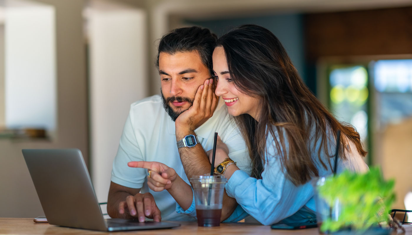 Couple reviewing travel plans on a laptop