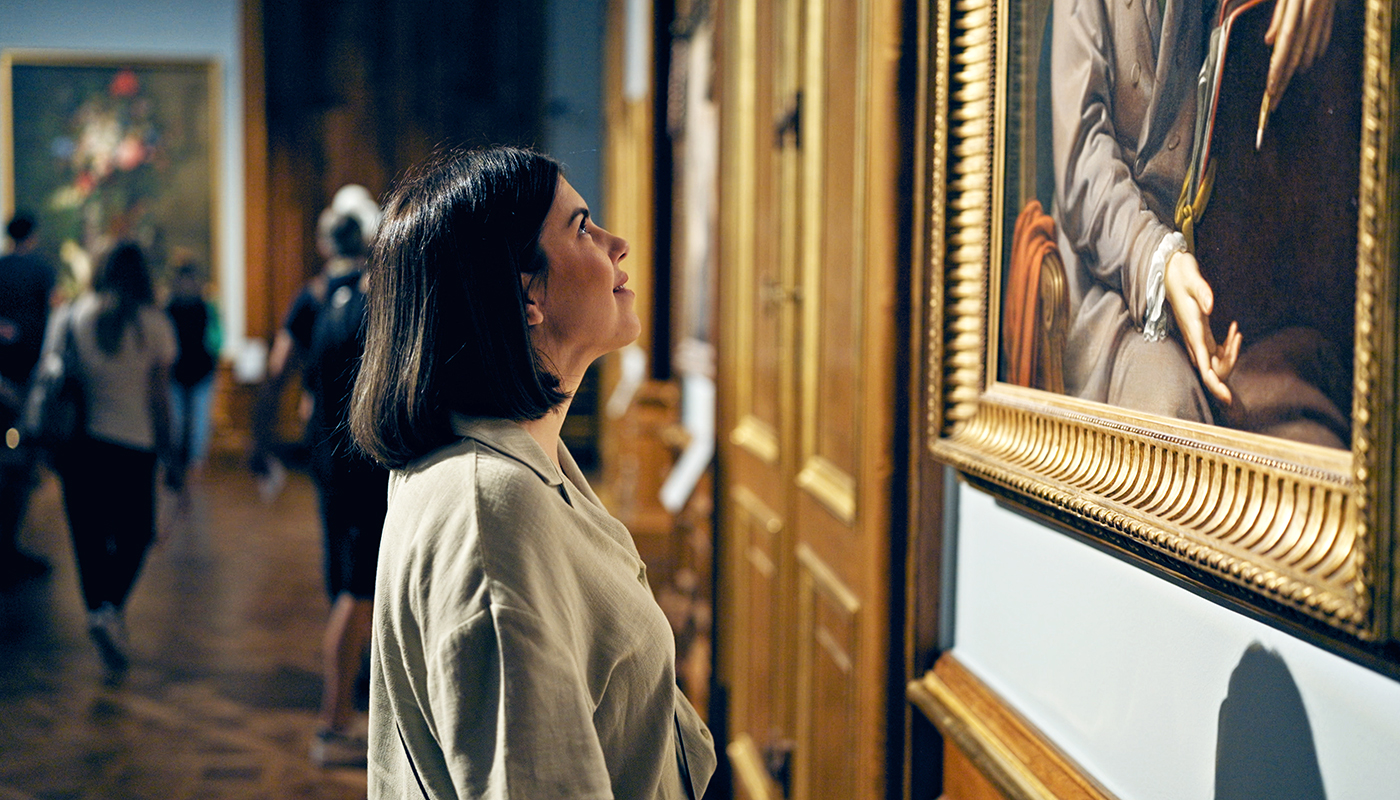 Young beautiful hispanic woman visiting art gallery at Belvedere Palace in Vienna