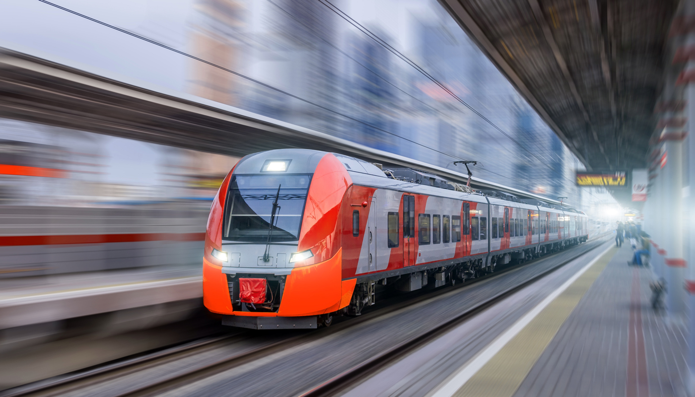 High speed train rides at high speed at the railway station in the city.