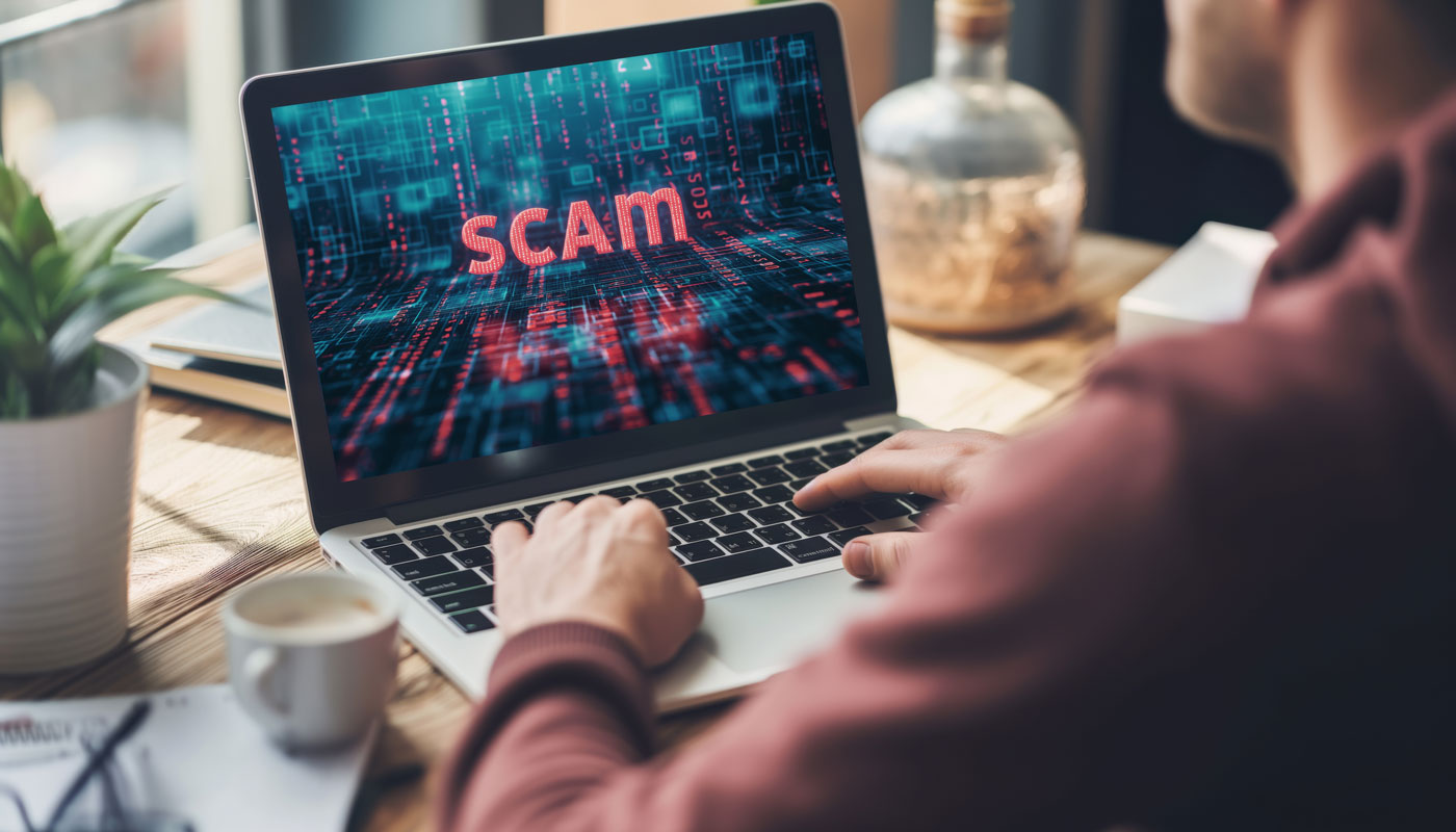 Online scam alert concept on laptop screen