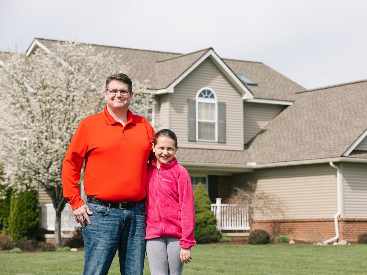 AAA member Patrick Harrell and his daughter, Natalie, outside their restored home