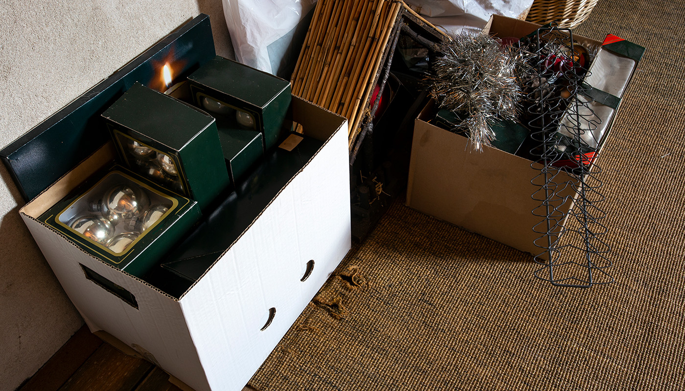 Overhead view of storage boxes, one contains Christmas decorations