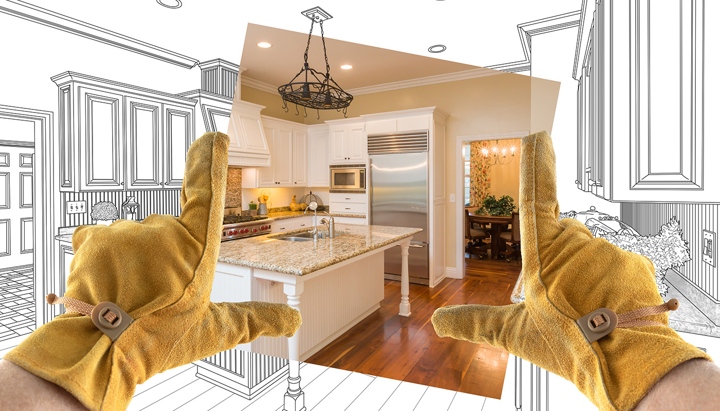 Gloved hands holding an "after" photo on top of kitchen rendering