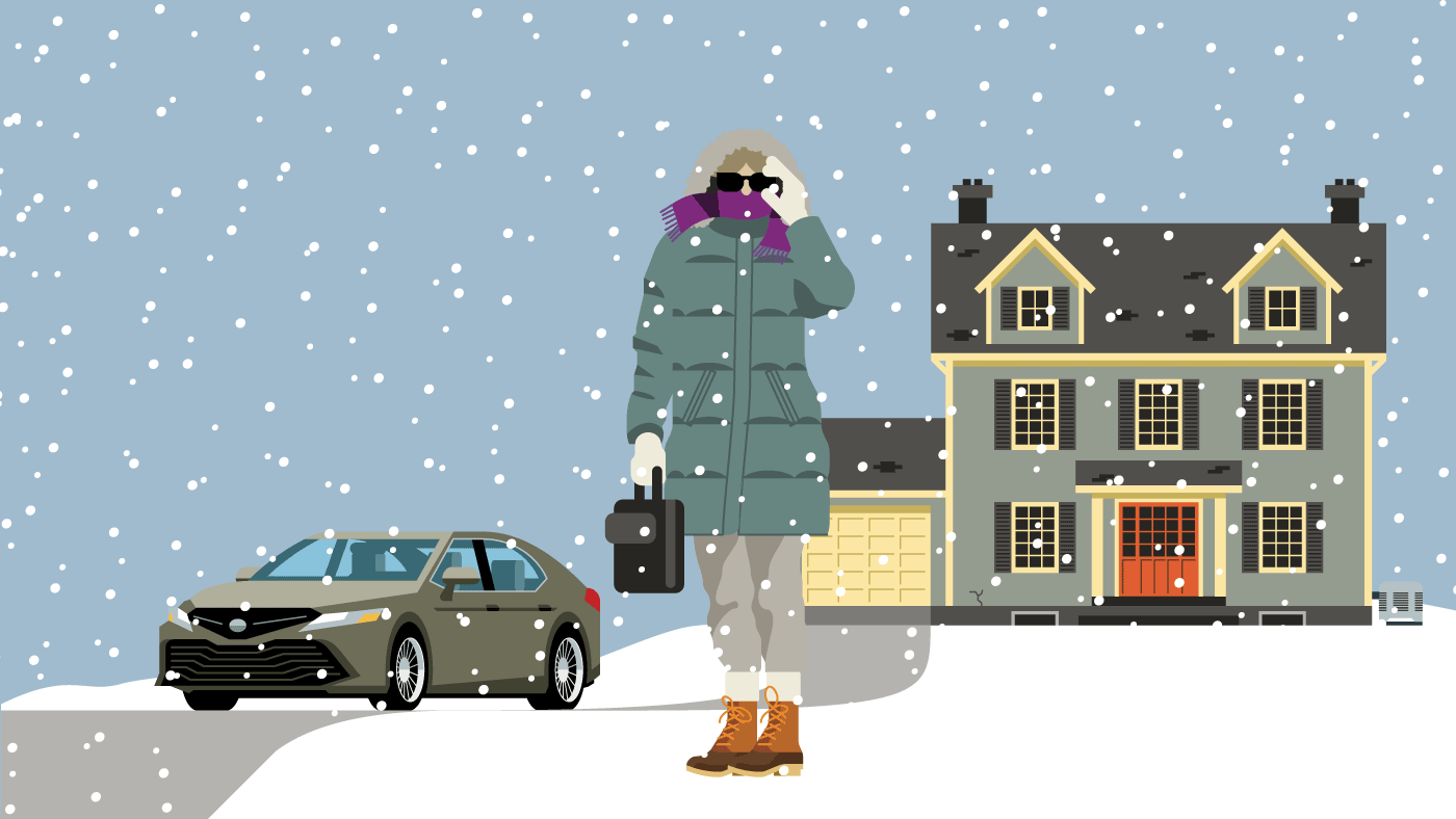 A person dressed in warm winter clothing standing in front of their house and car while snow falls around them