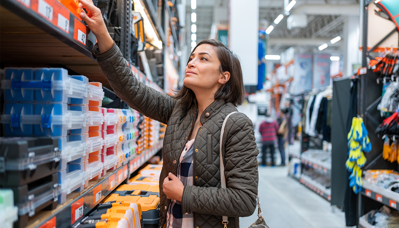 Photo of Latinx woman shopping in the aisles of a construction store