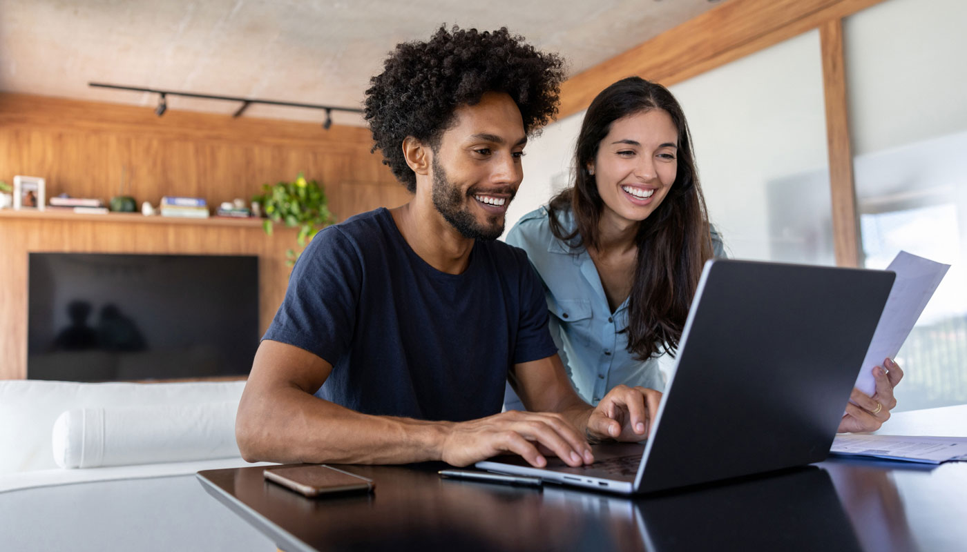 couple budgeting together on a laptop