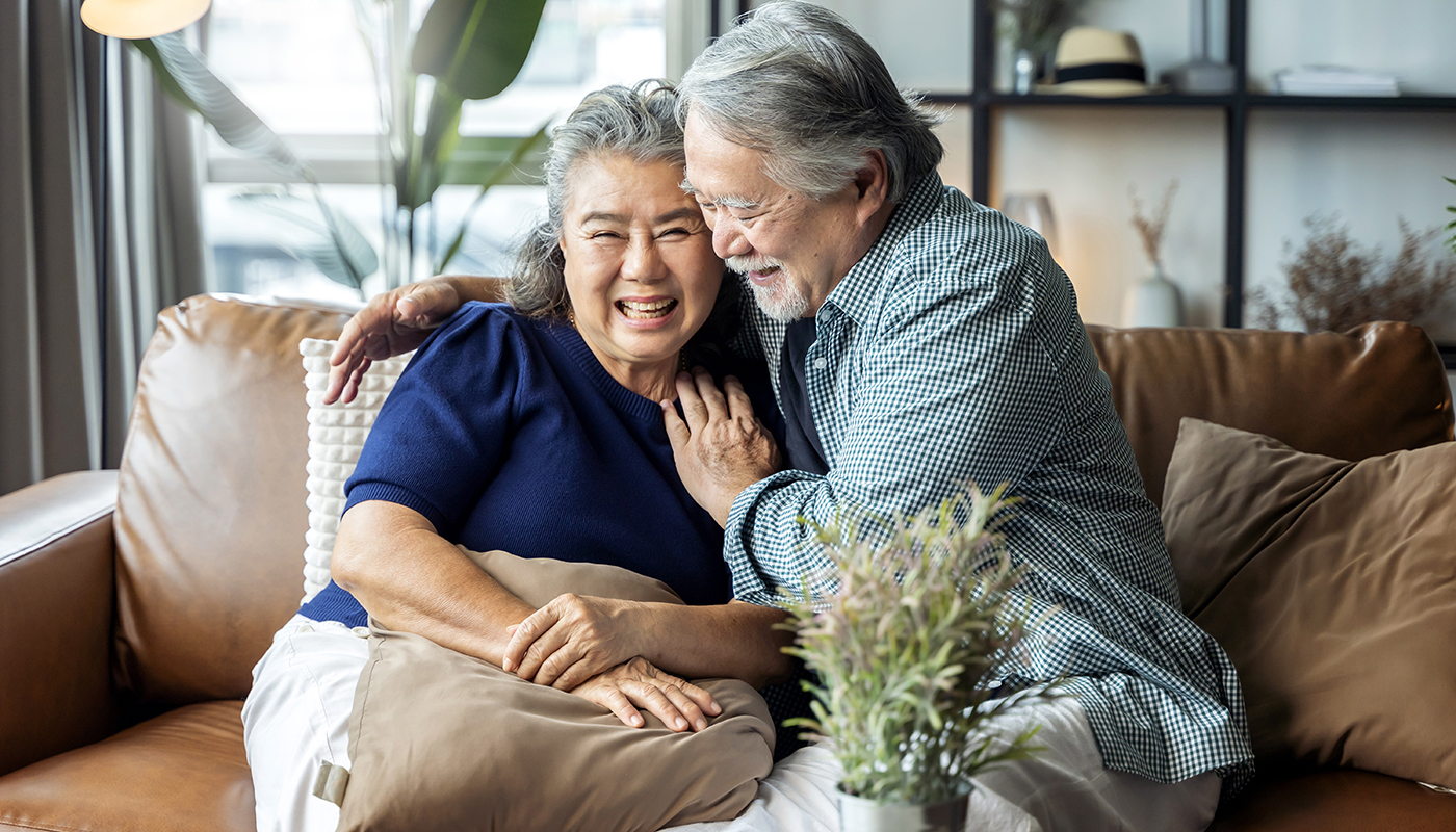 old senior asian retired couple enjoy talking conversation together on sofa with happiness laugh smile and joyful at home,asian old mature adult stay home quarantine period concept