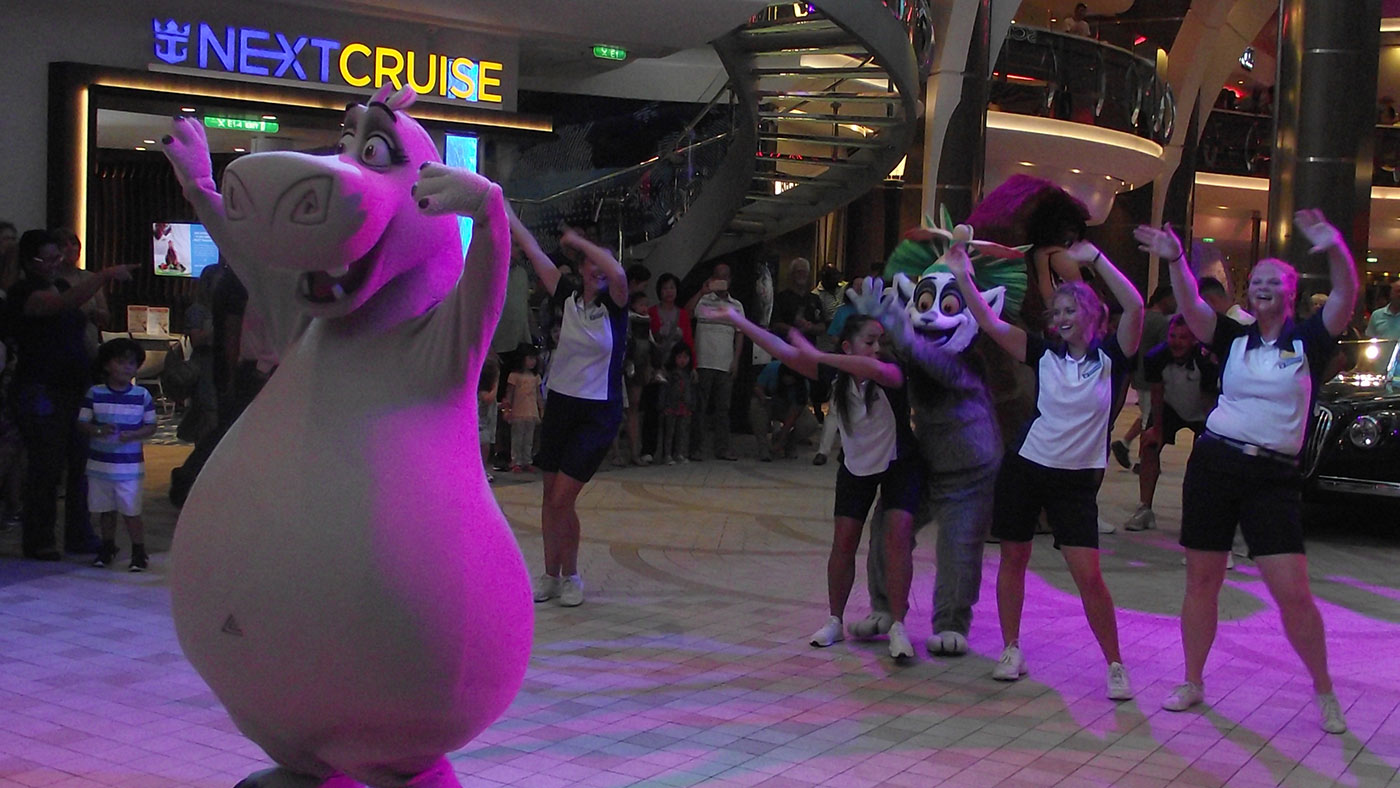 Watching a street party-style parade in the Promenade space of the cruise ship