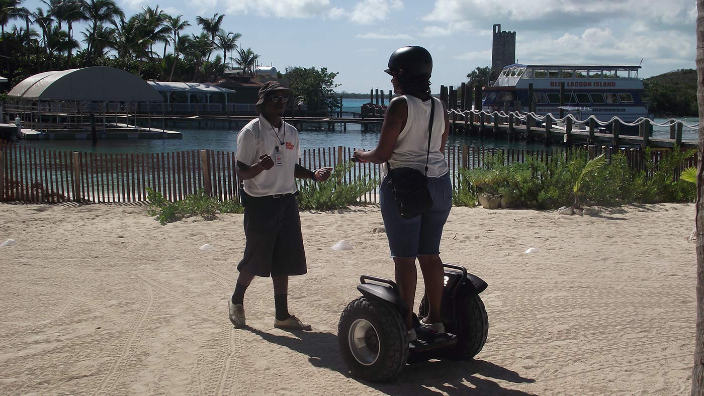A tourist learns to ride a Segway before a tour of Blue Lagoon Island in Nassau, Bahamas