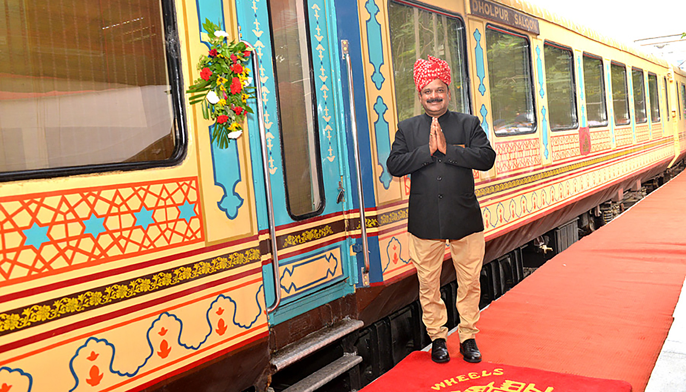The Palace on Wheels train with welcoming man