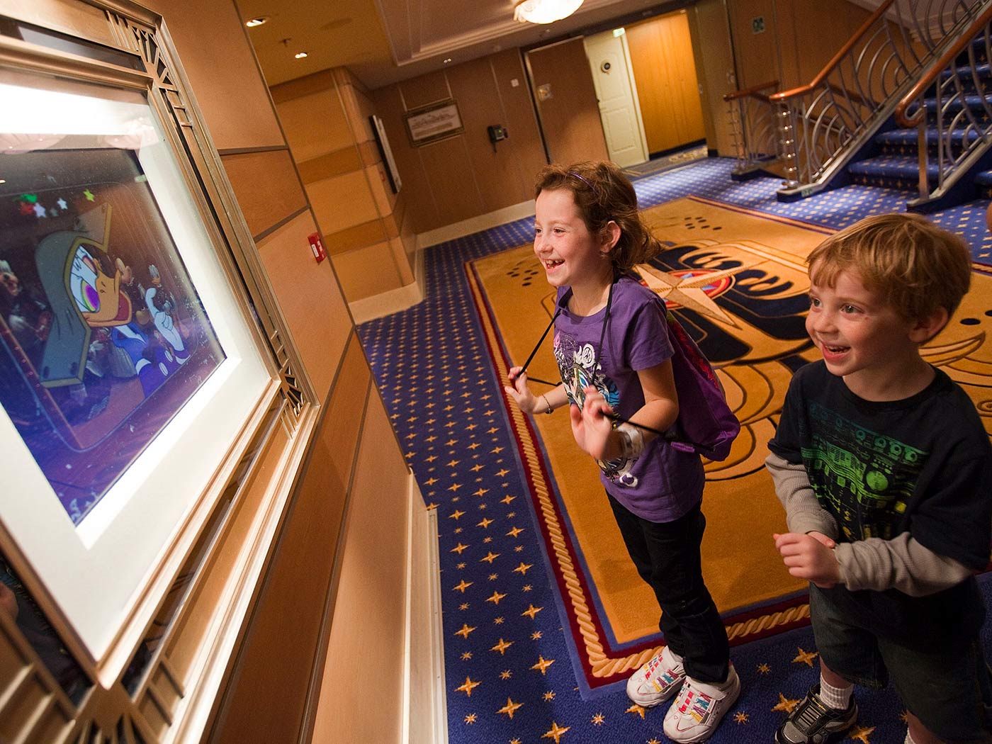 children watching television in cruise ship lobby