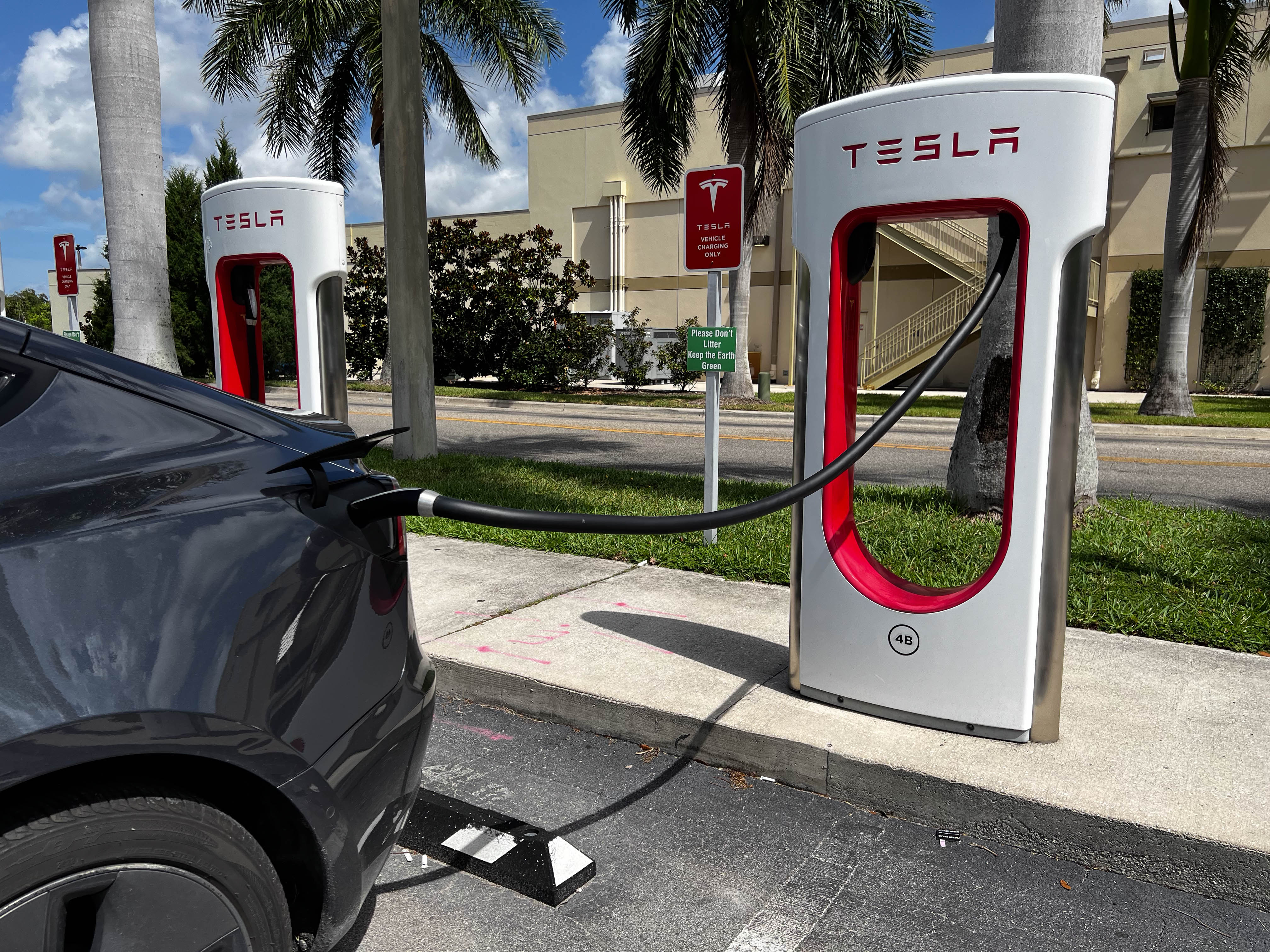 An electric car being charged at a Tesla Charging Station at the Sarasota Airport in Florida.