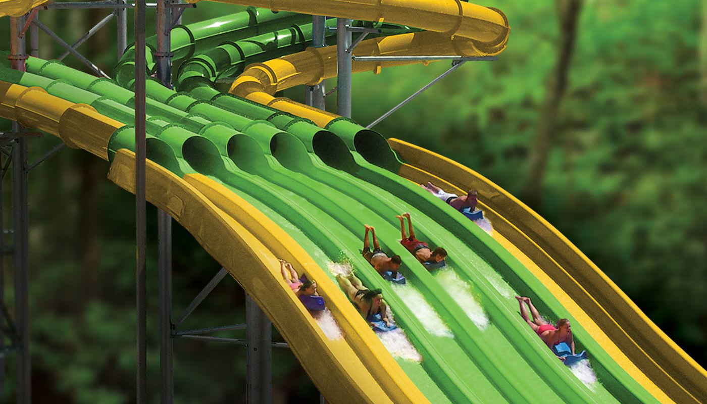 Park patrons racing down the TailSpin Racer water slide at Dollywood’s Splash Country