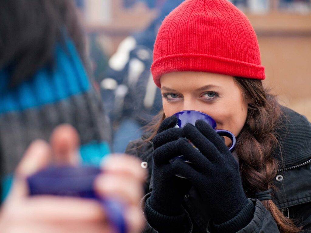 Evening strollers and apres-skiers warm up with glühwein