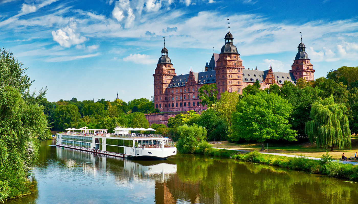 A Viking River Cruise vessel on the water in front of an old European building