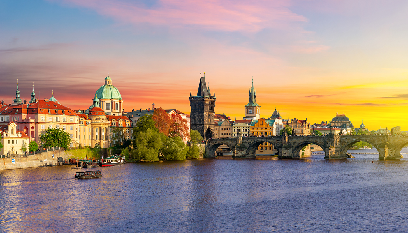 Prague panorama with Old Town Bridge Tower and Charles bridge over Vltava river at sunset, Czech Republic