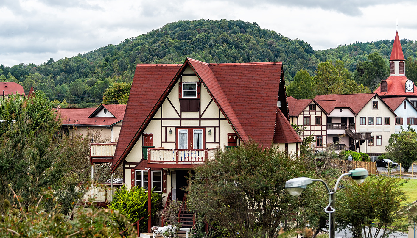 Red roofed buildings of German architecture with mountains in background