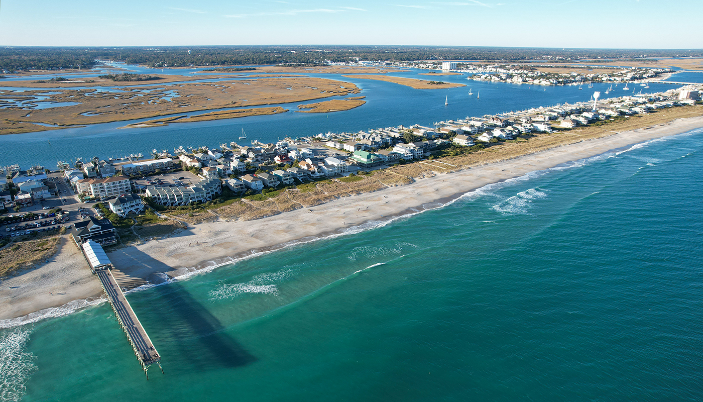 An aerial view of the sandy shores and rows of beach houses on Wrightsville Beach in North Carolina.