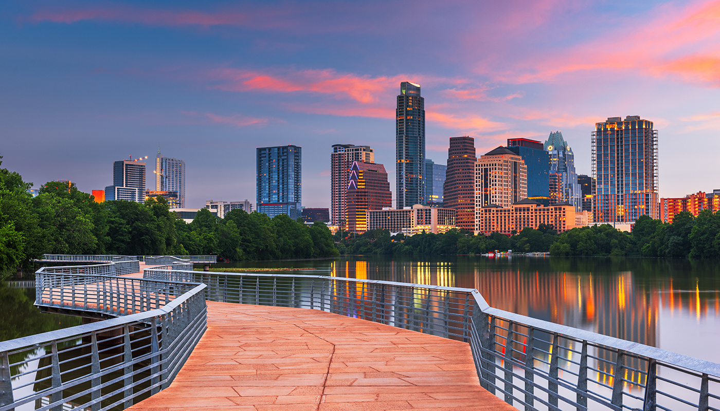 Austin, Texas, USA downtown skyline over the Colorado River at dawn.