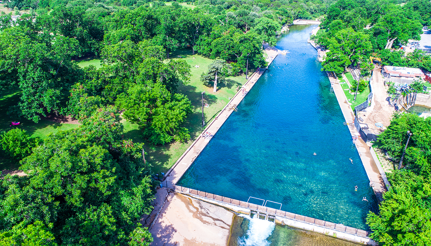 Looking across the Barton Springs Swimming Hole Turquoise Blue clear Spring water natural summer escape