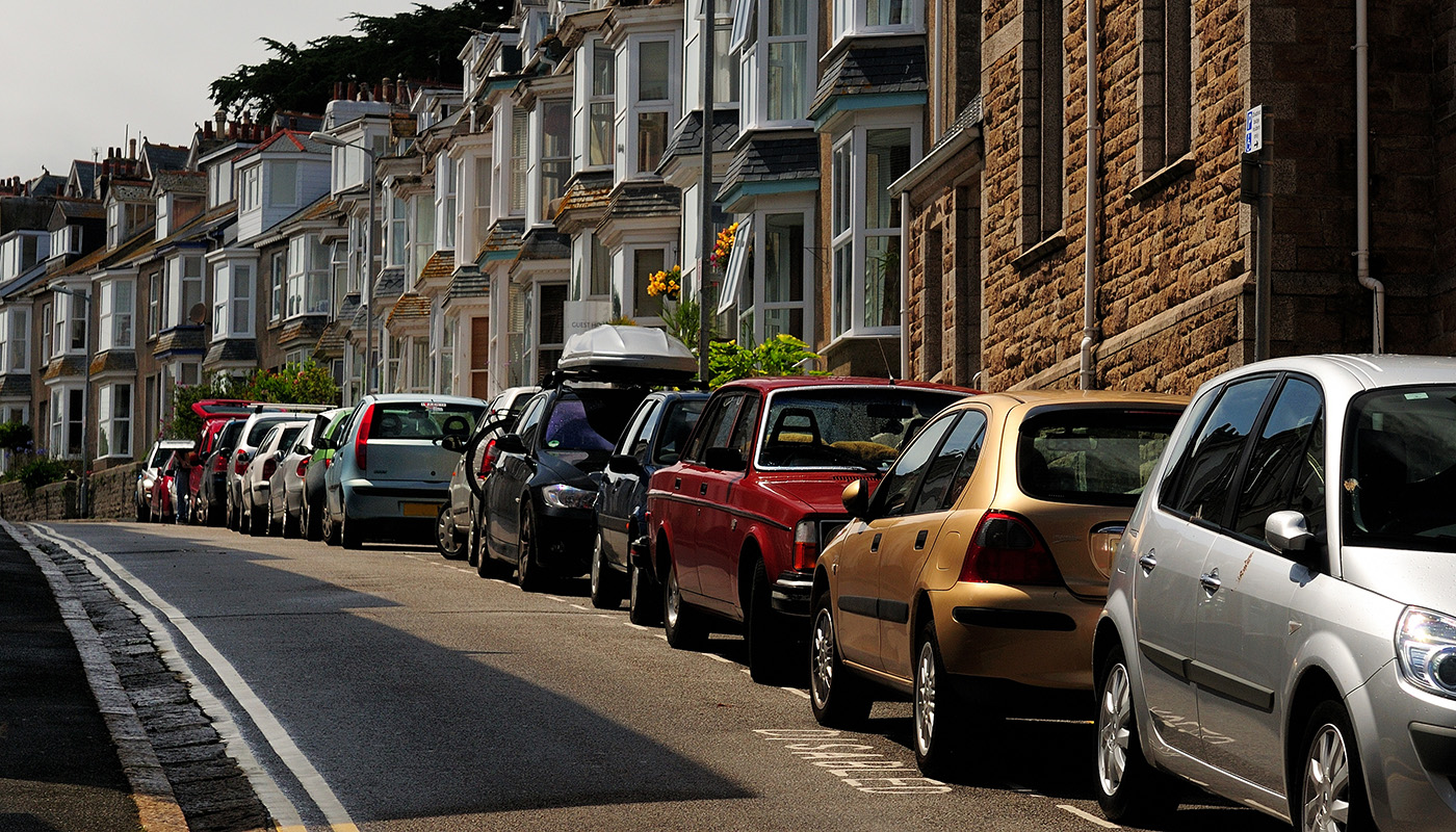 Cars parked in front of row houses in Cornwall, England