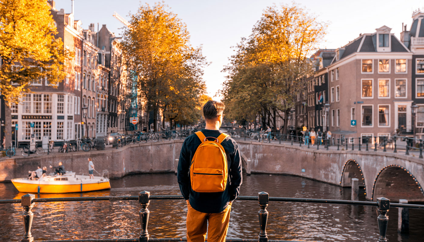 young male taking in the European view off of a bridge