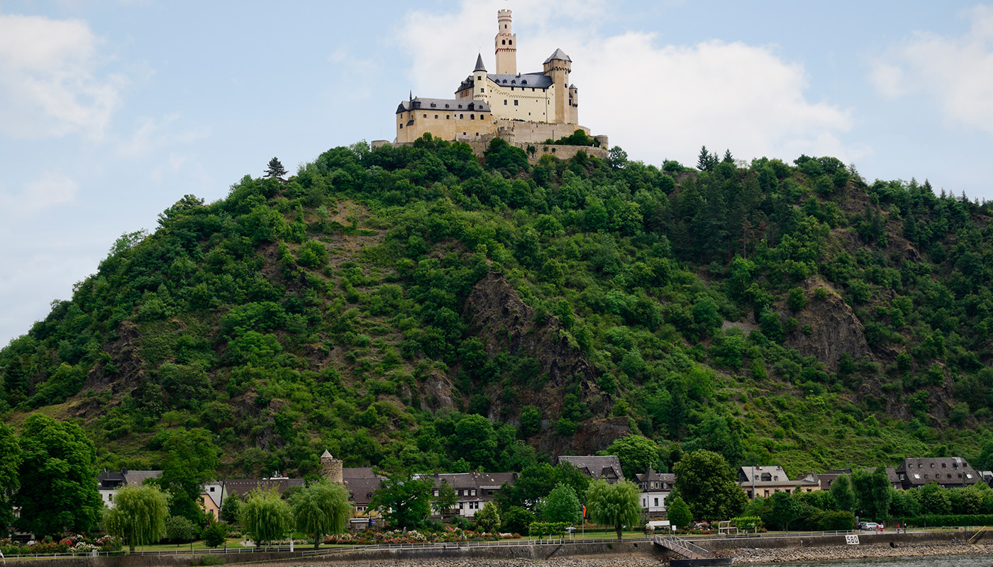 Marksburg Castle on top of hill overlooking village of Braubach in Germany