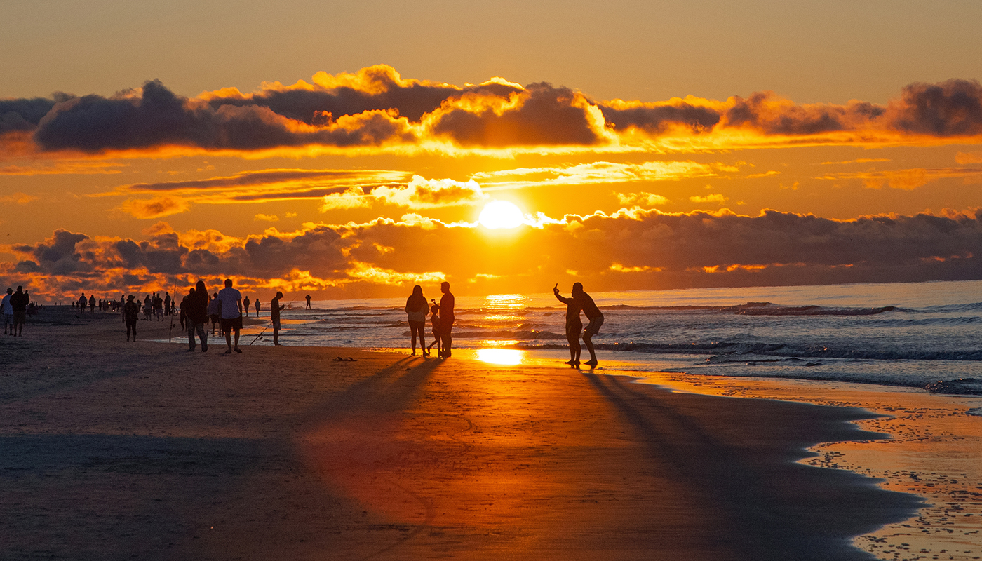 1250961955 Groups of people enjoying the sunrise in Hilton Head, South Carolina