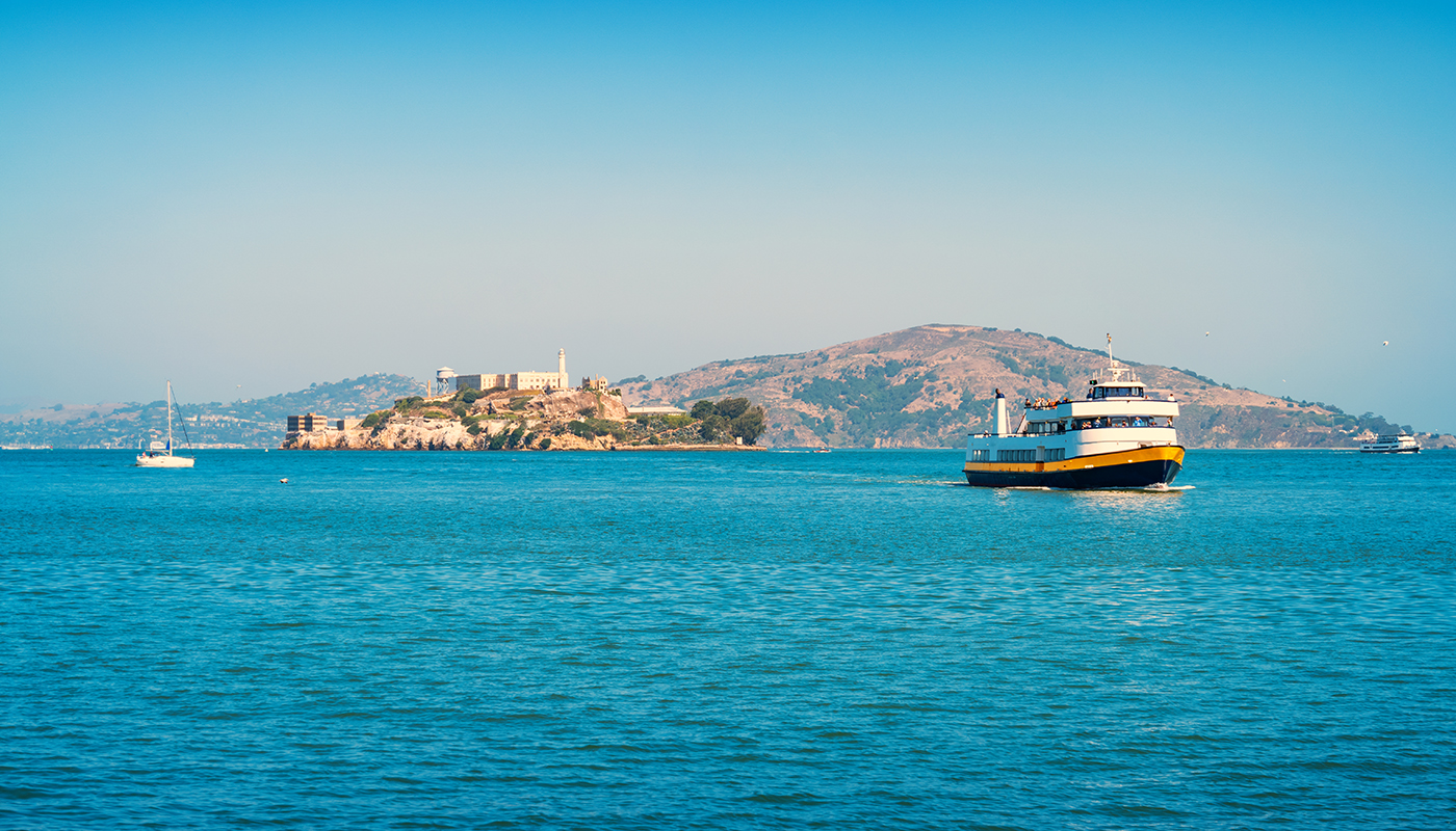 A ferry travels through the wide open bay of San Francisco.