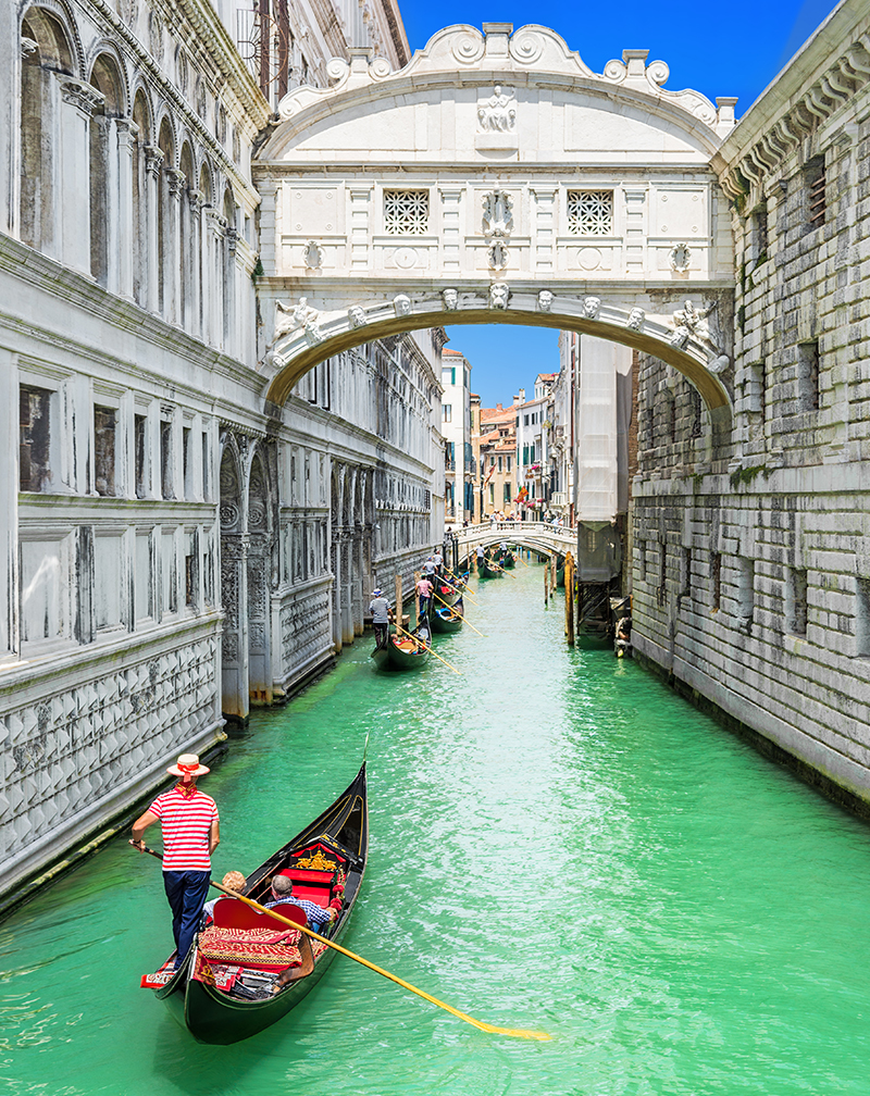 Bridge of Sighs and row of gondolas in Venice, Italy