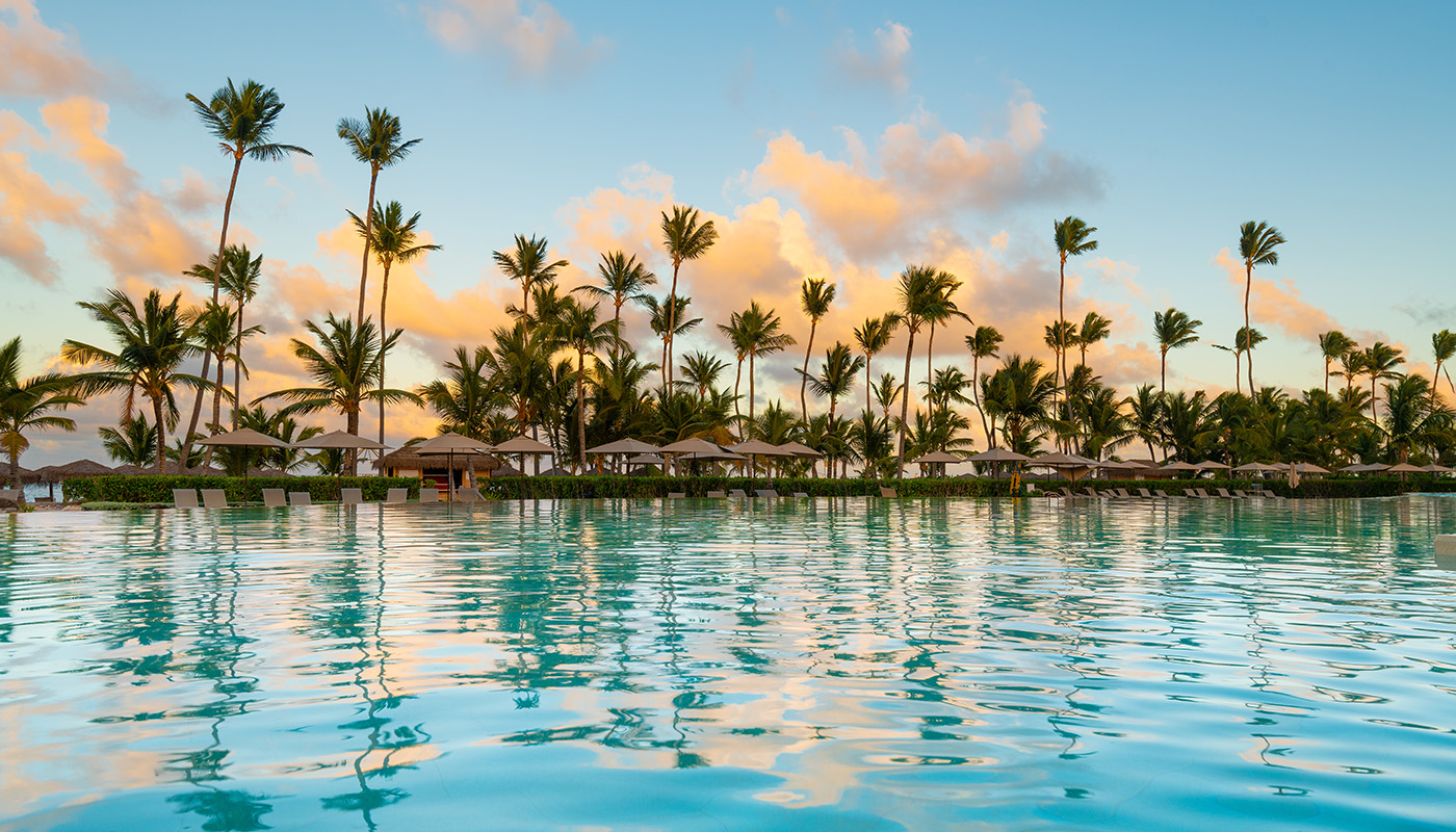 Swimming pool and palm trees at luxury resort in the Dominican Republic
